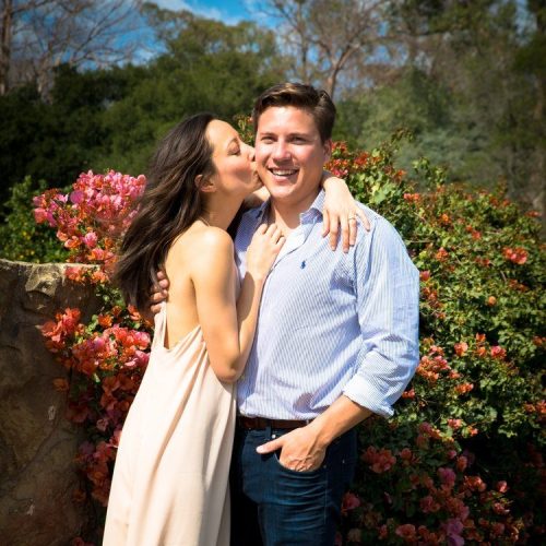 A woman kissing a man on the cheek.